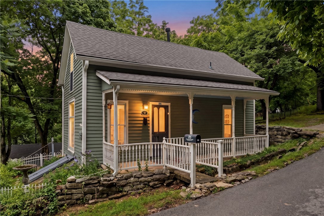 Charming Victorian cottage filled with timeless character and thoughtful updates in an ideal Eureka Springs location! Inside you’ll find wide-plank pine flooring, classic wainscoting, shiplap accents, built-ins, and inviting historic charm throughout. The remodeled kitchen features custom cabinetry, granite countertops, and updated finishes. The main-level bathroom offers a beautifully updated design with subway tile, a glass wall shower, and convenient utility closet, while the upstairs bath features a classic porcelain pedestal sink and a spacious clawfoot tub that perfectly complements the home’s Victorian style. Enjoy seasonal winter views of downtown from the covered back porch overlooking the fenced backyard. Detached one-car garage. Conveniently located just a short walk from downtown shopping and dining with close proximity to Jacob’s Ladder, a well-known walking path that connects directly to Eureka Springs’ downtown shopping district.