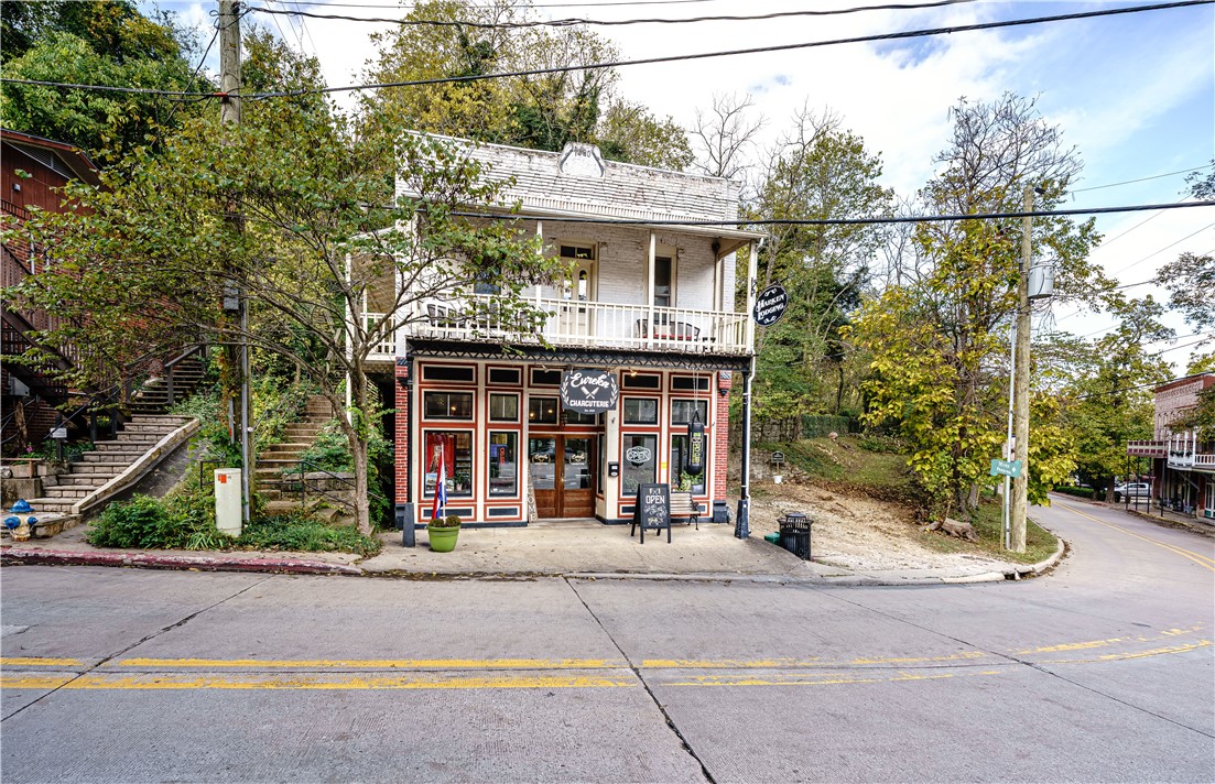 Multiple income streams provide the buyer with the opportunity for immediate cash flow from this commercially zoned property! Includes THREE non-restricted short-term rentals, parking, and a 1,200 SFT street-level retail space featuring an ornate double door entry, with no steps and easy accessibility for shoppers.  Retail space includes restroom and central HVAC.  This area of downtown is developing rapidly with the new Boodega storefront and coffee shop opening across the street and a new multi-unit cabin complex under construction next door. The property includes three 400+- sq. ft. one-bedroom nightly rentals, each with kitchenettes and balconies. This charming circa-1910 building sits next to Tibbs Alley, a picturesque city stairway leading directly to Spring St. Financials available to qualified buyers.  Short-term rentals are professionally managed by a company willing to continue services for a seamless transition.  State and Federal tax programs may offer up to a 45% tax credit on approved renovations.