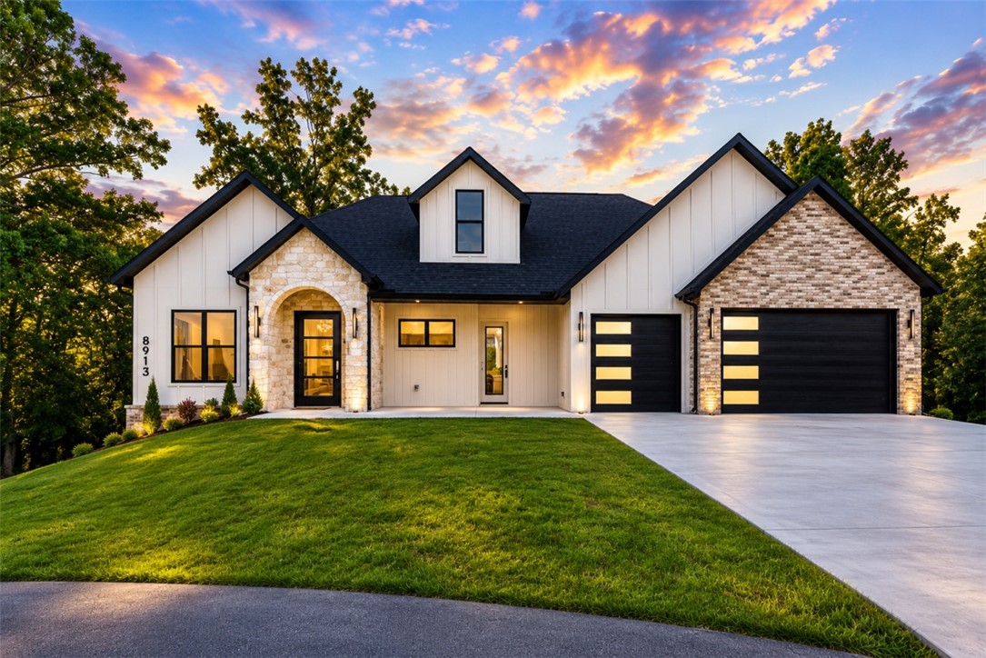 Tucked behind the gates of The Hollows at Beaver Lake, this European-inspired home invites you to slow down, gather often, and embrace lake-area living at its finest. Built by award-winning Key Concepts, it welcomes you with a stunning arched limestone entry, timeless stonework, warm natural finishes, and an effortless blend of elegance and comfort. Set on 1.08 private acres, this thoughtfully designed home offers 4 bedrooms, 3 full baths, 2 half baths, a private ensuite, and a spacious second living area perfect for guests, movie nights, or multigenerational living. Just 2.5 minutes from Prairie Creek Marina and located in the only gated community in the Prairie Creek area, you'll enjoy the rare combination of privacy, luxury, and convenience near downtown Rogers, Bentonville, and the Walmart Home Office. Every weekend feels like a getaway, and every day feels like home.