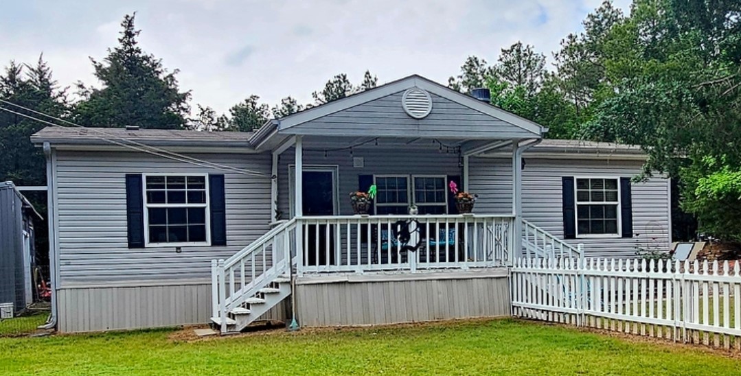 This well-maintained 3-bedroom, 2-bath home offers the perfect balance of peaceful living and everyday convenience. Nestled on 1.29 acres just minutes from Russellville, the home features a spacious layout, a welcoming living area, and a bright kitchen with plenty of storage. The primary suite includes a full bath and walk-in closet, while two additional bedrooms provide flexibility for guests, family, or a home office. Step outside to enjoy the beautifully landscaped yard, complete with a fenced area for pets and an above-ground pool—ideal for enjoying warm Arkansas days. Additional highlights include a covered carport and a detached shop, perfect for hobbies or extra storage. If you're looking for comfort, space, and move-in-ready convenience, this home checks all the boxes