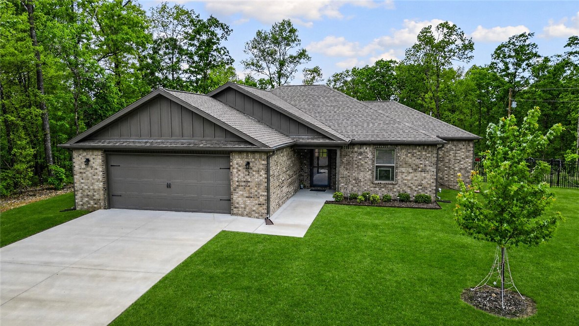 Positioned on a highly desirable rare flat lot in beautiful Bella Vista just minutes away from the Back 40 trails, this gently used 2023 all-brick home blends comfort, style, and natural surroundings. Offering 3 bedrooms and 2 baths, this move-in ready home features a well-designed split floor plan, modern finishes, and a layout that lives larger than its footprint. The open living and kitchen areas are ideal for gathering and entertaining, filled with abundant natural light, granite countertops, LVP flooring throughout, and a cozy propane fireplace. The private primary suite provides a peaceful retreat, while two additional bedrooms and a full bath offer flexibility for guests, family, or a home office. Additional highlights include storm doors, aluminum fencing, and an oversized 2 car garage. Enjoy easy access to Metfield recreation complex, bike trails, and Highway AR-94. Surrounded by Bella Vista’s natural beauty, this home offers an exceptional lifestyle you don’t want to miss.