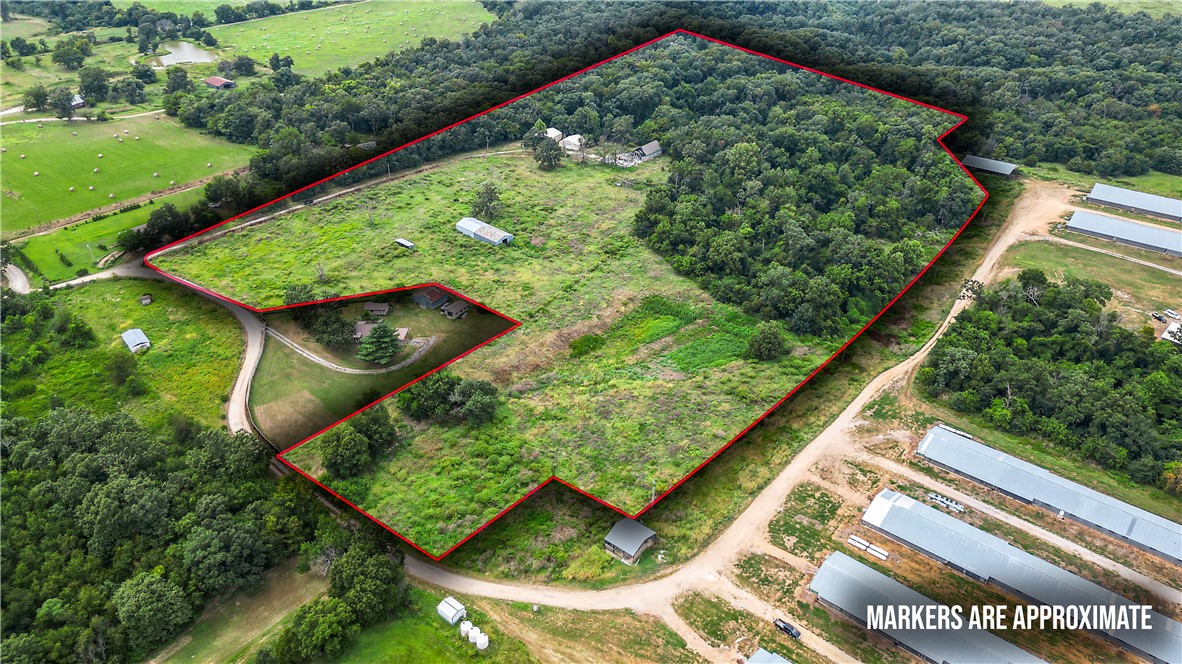 Unbeatable land investment opportunity in high-growth Northwest Arkansas. This versatile 21.03-acre tract offers exceptional potential—from starting your dream farm to residential development and long-term land investment alike. A 40-foot deeded easement off Ruby Hall Road provides secure access to a serene landscape composed of open pasture and mature Ozark timber. The property is fully outfitted with water and electric on site and extensive outbuilding infrastructure, including a 40x40 garage, a 40x40 open barn, 32x90 pole shed, a 10x30 pole shed, —delivering immediate functional value, great utility solutions, and turn-key storage for livestock, and heavy equipment. Conveniently located just 4 miles from Highway 12.  Previous home was in a fire and conveys at no value.