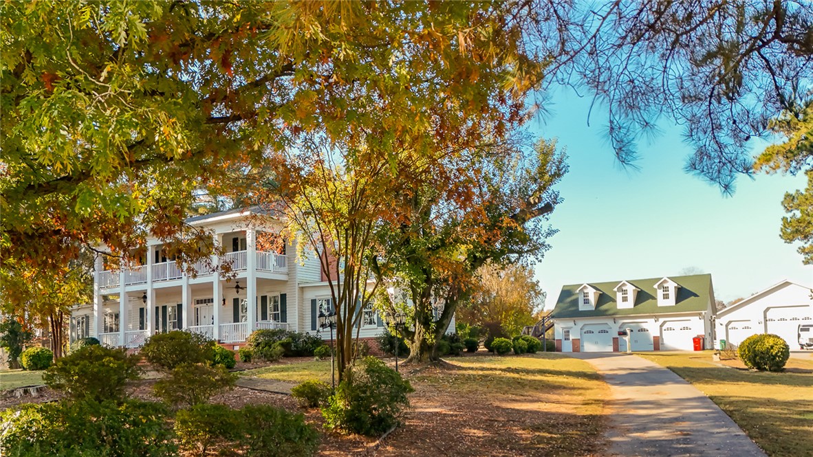 The minute you start down the narrow, tree-lined lane w/ immaculate pastures stretching off to your right—the anticipation builds. You just know that something remarkable is waiting at the end. And then, there it is...A 2 story Colonial home rising proudly in the distance. The wonder only deepens as you take in the Southern-columned front porch and balcony, the gleam of solid oak floors, the cherry-paneled den crafted at the turn of the century—every corner whispering a story. Set on 335 acres, this property offers an unmatched blend of history and modern functionality. The 4,447sq ft home anchors the estate with timeless elegance, while the guest house provides lodging for family & friends. The farm includes 2 detached, heated & cooled, 3-car shop/garages, perfect for equipment, hobbies, or storage, as well as a barn with tac room & office. There's also a vintage log cabin placed on the property like a scene from a storybook—ideal for a studio or office. Fenced pastures & open skies surround you in every direction