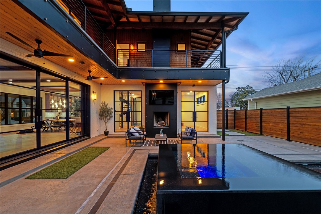 URBAN SOPHISTICATION at its finest! A rare architectural masterpiece in downtown Bentonville, this brand-new 2024 custom residence blends brick, cedar, and steel to create a striking yet warm modern estate. Positioned on a coveted .27-acre corner lot on the SW side of downtown, the 5,700 sq ft home showcases 5 bed/4.5 baths w/white oak floors, South African marble, walnutA beams, and custom millwork define the interiors, 16 steel exterior doors and an 18-ft pocketing steel wall create seamless indoor/outdoor living. A dramatic living room glass floor reveals an underground brick wine/bourbon cellar. The chef’s kitchen features TRUE commercial refrigeration, an Italian gas range, marble island, hidden pantry. Two-story primary suite offers a raw steel fireplace, heated spa bath, private office, outdoor bath with soaking tub/shower. A heated black concrete pool, infinity spa, outdoor kitchen, fireplaces, RV pad w/ hookups, oversized garage create a resort-style retreat just blocks from the Square and Crystal Bridges.