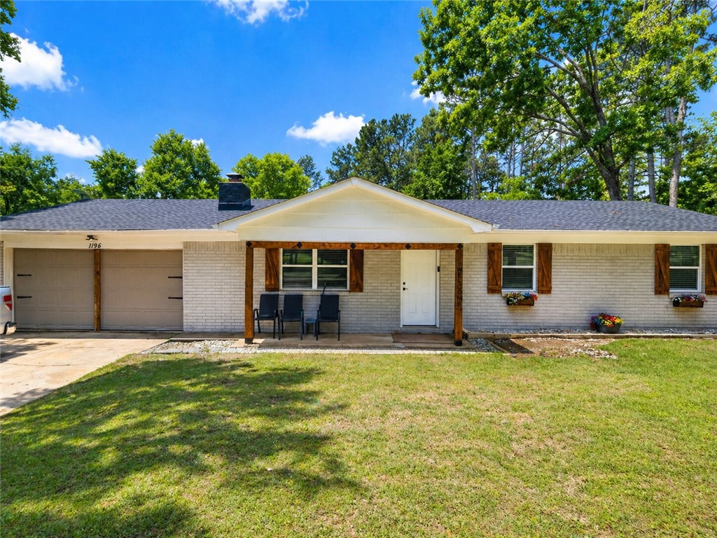 Nestled in the desirable Mill Creek area just outside of town, this beautifully updated 2 bed, 2 bath home offers the perfect blend of charm, comfort, and space. Situated on 3 peaceful acres on a corner lot, this property features a newly remodeled kitchen with butcher block countertops, fresh interior and exterior paint, and gorgeous new LVP flooring throughout. The cozy wood-burning fireplace with custom built-ins creates a warm focal point in the living area, while the stunning brick accent wall adds character to the dining space. The spacious sunroom off the back offers endless possibilities as a home office, playroom, or potential 3rd bedroom. The primary suite includes a separate sitting area, updated bath w/walk-in shower, & private access to the large back deck. Covered area of the deck could easily be screened in for added comfort . Additional features include a laundry room off the kitchen, 2-car garage, & new outbuilding for extra storage. HVAC 2 yrs old, Roof 4 yrs old, Windows 3 years old.