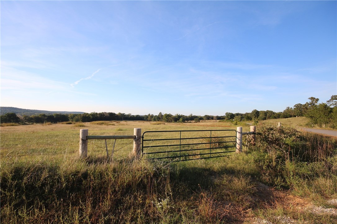 Incredible piece of land on the White River in prestigious residential growth area of Fayetteville. Endless investment potential. Beautiful potential home sites w/ views overlooking river bottom. Access to city water & utilities. 50/50 open/timber. Multiple access points off paved rd. Tillable production acres +pasture land & pond to support numerous cattle. Wire fencing & cross fencing. Recreational trail system. Great fishing, deer sign, natural vegetation, potential food plot sites. Boat ramp nearby.