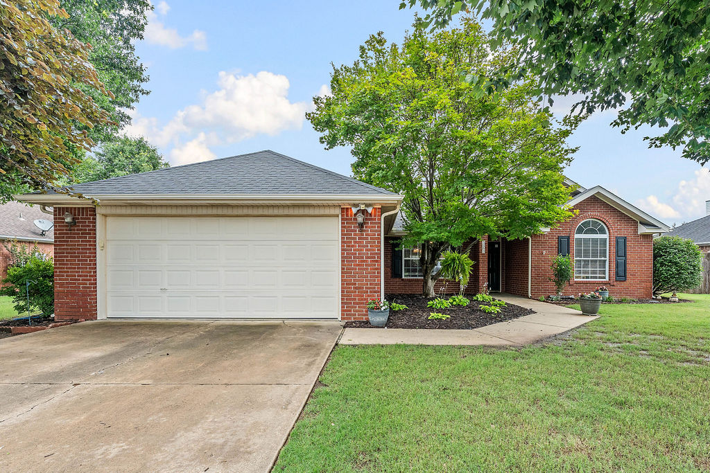 This beautifully maintained 3-bedroom, 2-bath Lowell home offers the perfect blend of comfort and convenience. Located minutes from I-49, enjoy an effortless commute to Northwest Arkansas’s premier corporate corridors, Fortune 500 employment hubs, dining, and shopping. Inside, an open, light-filled layout features soaring vaulted ceilings and gorgeous hardwood floors flowing through the main living areas into an inviting kitchen and dining space. The highly desirable split floor plan ensures maximum privacy for the spacious primary suite, complete with vaulted ceilings, a walk-in closet, double vanity , and a fully tiled shower. A true standout feature is the heated and cooled sunroom; equipped with a dedicated mini-split system for year-round enjoyment, this versatile bonus space adds incredible value not included in the official square footage. Outside, a manicured fenced-in yard with an integrated irrigation system provides the perfect backdrop for outdoor entertaining. Move-in ready and a must-see!