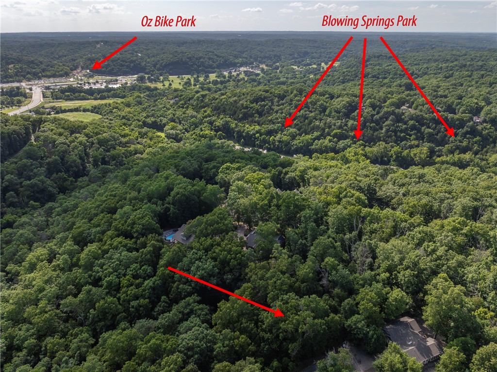 Adventure is practically in your backyard—cut a trail from the property and drop onto the Blowing Springs trail system, then bike or hike down to the popular beer garden. This lot if primed for you to build your dream home in the trees on this wooded half-acre lot tucked away at the end of a quiet cul-de-sac in Bella Vista. Exceptionally flat for the area, giving you more flexibility when it comes to designing and building your home. The lot has already been perc tested for a 3-bedroom home. Located just 5 minutes from Hwy 71, offering convenient access to Bentonville, shopping, dining and everything Northwest Arkansas has to offer. Located in the Bentonville School District. A great combination of privacy, trees, trails and accessibility.