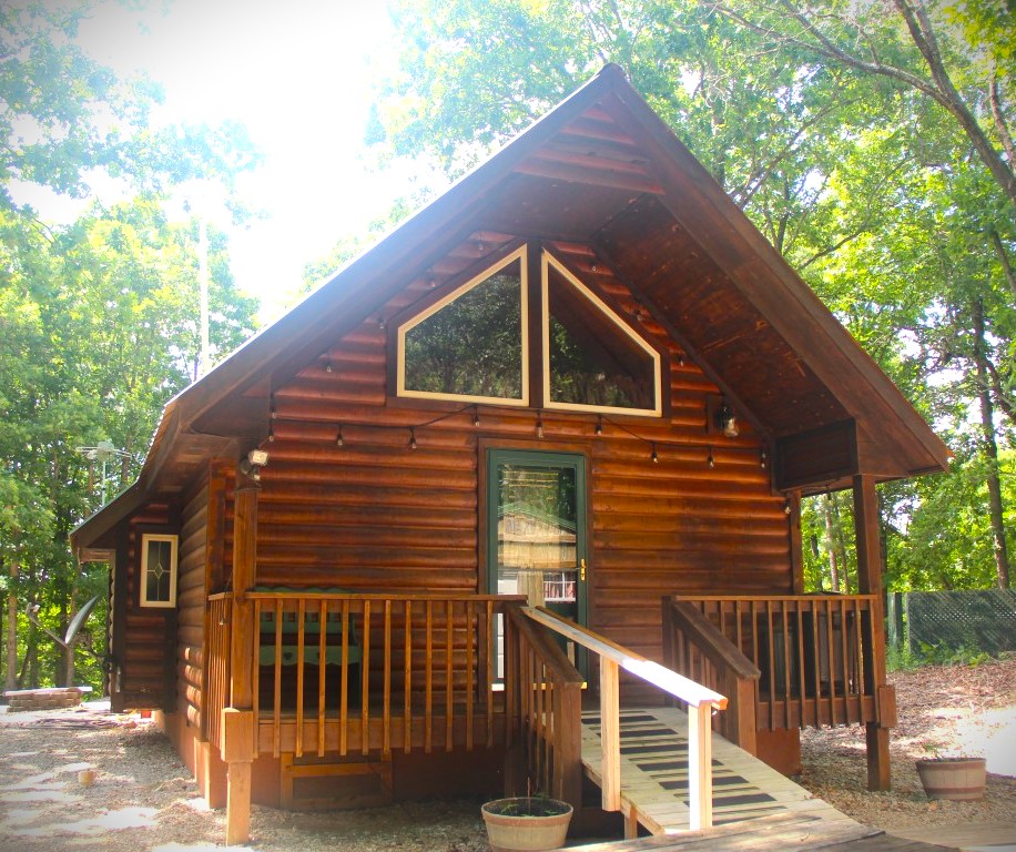 An exciting opportunity awaits between Bentonville and Eureka Springs, AR! Nestled on 6.33 pristine, heavily wooded acres, this stunning log cabin delivers privacy in a small 4-cabin gated community. Perfect for nature lovers. The covered deck is your front-row seat to wildlife and birdwatching. The interior comes turnkey and furnished, highlighted by a cozy ambient gas log fireplace. Home features both a jacuzzi tub and a walk-in steam shower. Beyond the main home, the property offers incredible versatility: a workshop, two Derksen buildings and a woodstove-heated shed offer lots of storage potential. An on-site storm shelter adds invaluable peace of mind. Ideal as a high-yield short-term rental investment or your own hidden sanctuary. Just a few miles to White River, Beaver Lake, Oz Bike Trails and Lake Leatherwood Park.