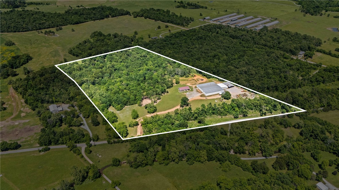 30 acres m/l of stunning rolling land in the highly desired Honey Creek area just outside the city limits. This versatile property features a blend of open pasture & partially wooded acreage, creating endless opportunities for recreation, hunting, trail riding, livestock, a private shooting range, or future development. A fully stocked pond is perfectly positioned to capture breathtaking views across the scenic landscape. Build your dream home on this beautiful acreage or take advantage of the potential for a business venture with substantial existing improvements already in place. Property includes a 3,000 sq ft office building with potential for residential conversion, plus an impressive 31,000 sq ft warehouse/manufacturing facility ideal for commercial, industrial, storage, or investment use. Well and septic are already on site, with rural water available at the street. Rare opportunity to own multi-use acreage in a prime location w/ unlimited residential, recreational, agricultural, or commercial possibilities.