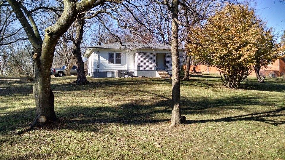 This is an older but solid home w/ lots of upgrades. Nearly 1,200 sq. ft can have 3 bedrooms, and 1 bath. Large open kitchen and dining room, large living room, storm cellar, covered porch on front and carport on back. The home has a new roof, new Heat/Air unit, new carpet, tile, and laminate flooring(all over wood floors), new ceilings, and fresh paint. The large 1/2 acre lot is filled with trees & flowers giving it a feel of privacy yet within walking distance to schools, community center, and grocery.