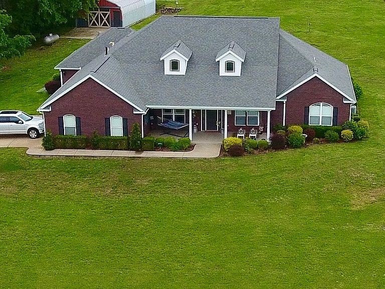 This executive estate style home sits on 10+ beautiful acres down a private drive that is fully paved. Beautiful 4 bedroom, 4 bathroom, 3 car garage home on 10.50 acre parcel in rural Siloam Springs. Bonus room could make a 5th bedroom.  Beautiful custom cabinets in study/office room.  Large, gourmet kitchen with beautiful custom cabinetry, center island, and granite counter tops. Formal and eat-in dining areas. Huge living area with fireplace and high ceiling. Luxurious master bath suite with whirlpool tub and tiled walk-in shower. Spacious laundry room has with counter space, utility sink, and built-in ironing board.