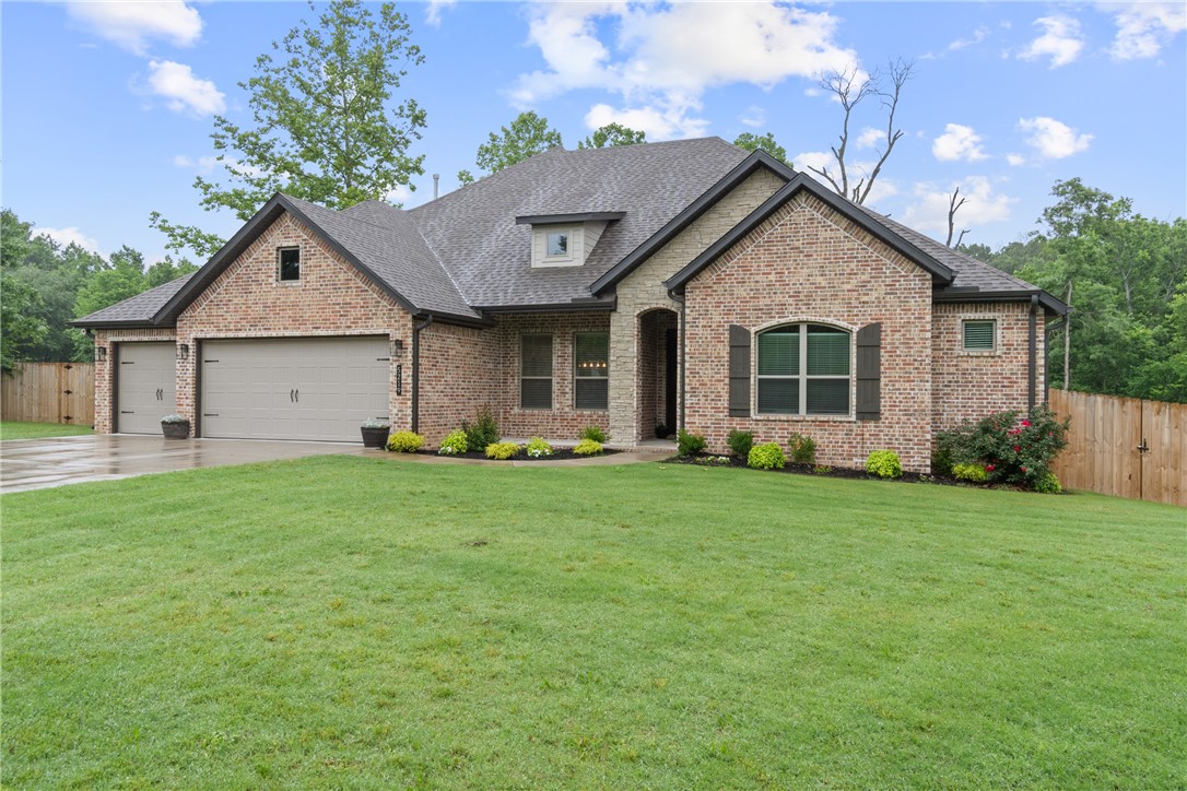 Nestled on nearly an acre and backing to a serene wooded setting, this four bedroom, three full bath brick residence offers refined comfort and timeless appeal. A striking front entry opens to a light-filled interior adorned with sophisticated paint tones, beam ceilings, and an inviting, open-concept design. The generously sized eat-in kitchen flows seamlessly into the main living area, ideal for both everyday living and elegant entertaining. A well-designed split floor plan provides a private primary suite featuring a spacious walk-in shower and an expansive walk-in closet, along with a separate mother-in-law suite on one wing. On the opposite side, two large guest bedrooms are connected by a Jack and Jill bath. Elevated lighting, designer hardware, and a substantial utility room add both beauty and function. The covered back patio offers a peaceful retreat overlooking the natural landscape, perfect for quiet mornings or hosting guests.