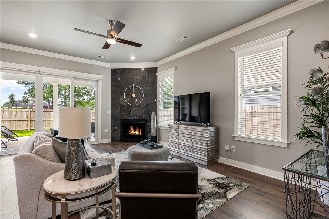 Immaculate custom cottage where timeless charm meets modern sophistication. Better than new & meticulously maintained, versatile floor plan offers 3 bedrooms or 2 private ensuites + dedicated office/flex space.  Abundant natural light pours through oversized windows, accentuating the soaring ceilings & creating an open, airy feel. The living area features a stunning floor-to-ceiling tiled fireplace tucked into a cozy corner. The kitchen combines style and functionality w/quartz countertops, custom cabinetry, & Frigidaire Professional appliances. Quartz surfaces continue throughout the home.   Step outside to the 19x13 covered back porch, ideal for morning coffee, entertaining guests, or unwinding in the evening. Whole House Generator. Dual zone HVAC. Low-maintenance community, the POA provides front lawn care & irrigation.  Furnishings & appliances are available, exceptional turnkey opportunity in one of Rogers' most desirable cottage-style communities.   Apple Blossom Trailhead is just down the street.