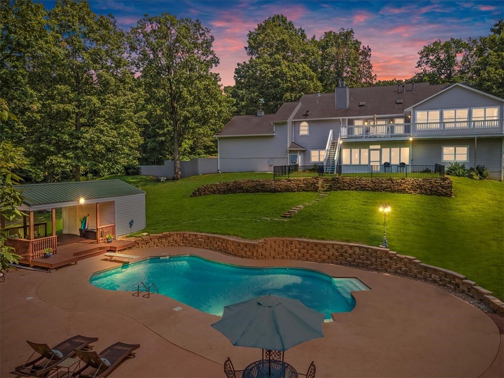 Amazing Beaver Lake Estate! Own your own private peninsula on 26.7 lakefront acres. This amazing property features a 5,494 SF estate home, private in-ground pool, covered pool house deck, horse stables w/ tack room, 65'x24' workshop, gated asphalt drive, & a hard to find private boat dock that's solar powered w/ 2 slips & lifts & lockers. This is lakefront living at it's best! Main home features all wood flooring & tile in bathrooms (no carpet) throughout entire home. Main level includes master bedroom w/ additional sitting area facing the lake plus office, formal dining, & 2 more spare bedrooms. Finished walk-out basement w/ media room, huge sunroom, large storage, & 4 more bedrooms. Chef's kitchen w/ center island, stainless apps, 2 ovens, gas range, trash compactor, ice maker, & more. Don't miss the mixer lift in center island cabinet (perfect for your heavy KitchenAid mixer). Geothermal duel fuel heating & cooling system (very low utilities). Huge 105 Gal Marathon water heater. Private salt pool & so much more!