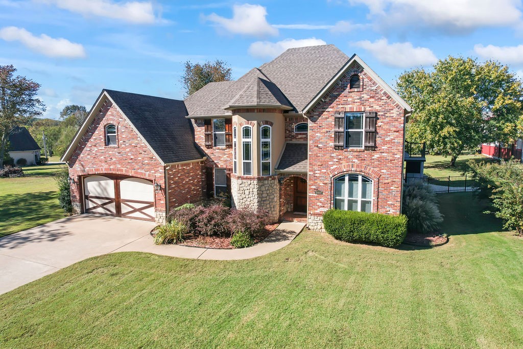 Gorgeous  4 bedroom home 2 1/2 bath home with private boat slip which includes a 7000# lift and swim deck within very easy distance from home. Priced Below Appraisal! New Heat pumps and A/C units. Central Vac  On-Demand Hot water.  Granite countertops and knotty alder kitchen cabinets.  Master is on main floor.  2 sided gas  fireplace between master bath and master bedroom.   Beautiful sun room addition with walls of windows with relaxing hot tub. New roof in 2020.  The garage is heated and cooled and this is where the F-5 rated safe room/tornado room is located.   $175 annual dock fee