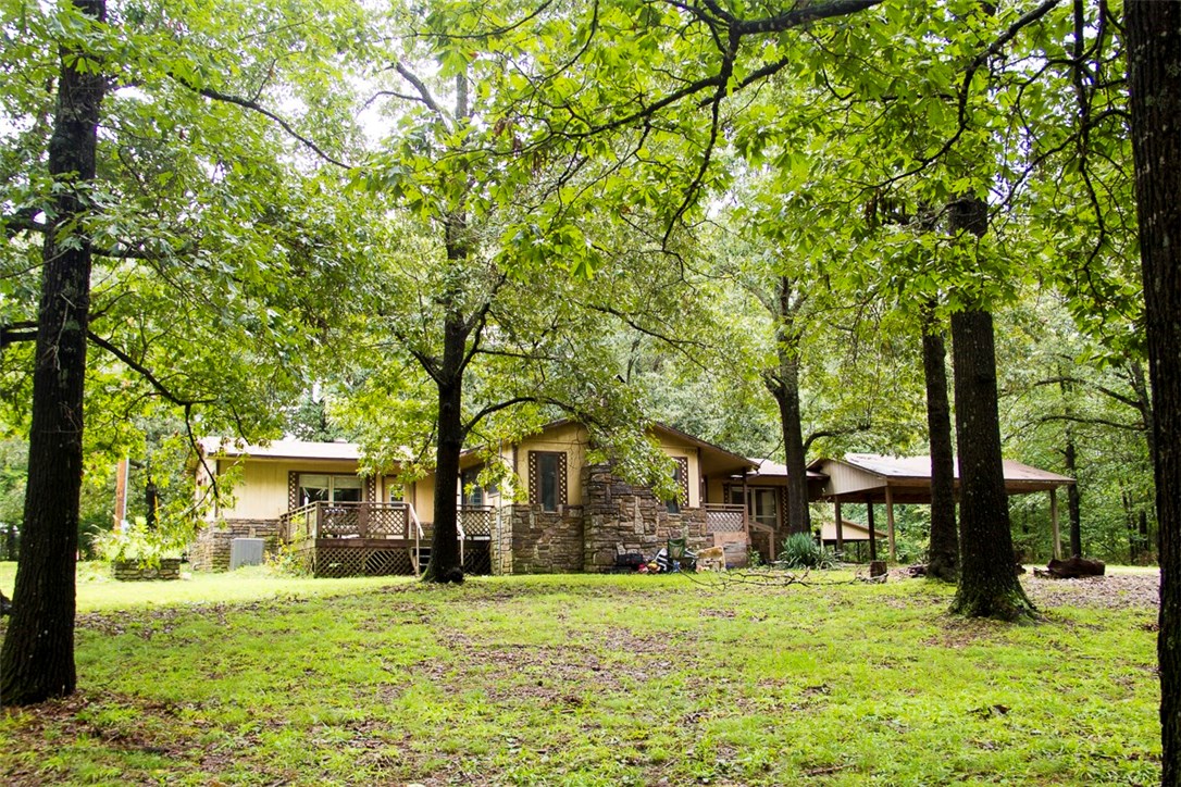Beautiful 1.28 Acres with 1,628 sqft 3 bedroom 2.5 bath home nestled among the trees. Country living with a great location! So much potential. Home is dated and needs quite a bit of TLC, but at only $125,000 it won't last through the weekend. New HVAC system installed in 2017! Huge master bedroom with walk in closet. Large family room. Workshop with loft. Covered pole barn style structure, two car attached carport. This home is being sold as is, and is priced to sell Quickly.
