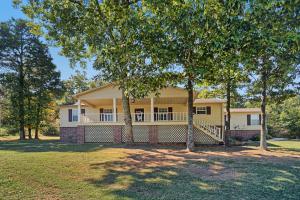 All the space and privacy of country living, but just minutes from big town life! This 4 BR, 3 BA home received some major TLC in the way of recent updates, including solid surface flooring in common areas and elegant new granite counter tops! The master bath is a spa-like dream with a huge jetted soaking tub and separate shower space. Take advantage of this home at a steal!