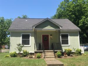 Quaint Little Cottage, Close to Downtown. Features living room with arched opening to dining room, both with original hardwood floors.  Updated kitchen and remodeled bath with walk-in shower.  Two large bedrooms with nice closets.  Laundry room and detached garage.