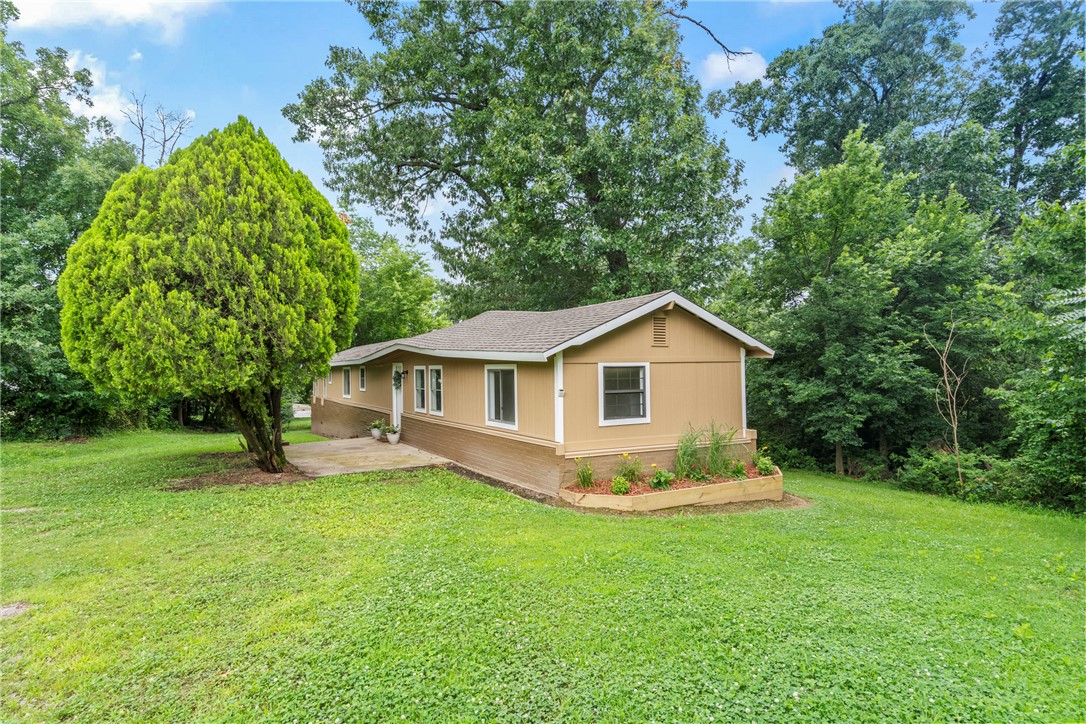 Completely remodeled and move-in ready! This updated 3-bedroom, 2-bath single-wide mobile home sits on a spacious 0.61-acre lot just outside the city limits, offering a peaceful setting with room to enjoy. Recent updates include a new roof, fresh interior and exterior paint, and new carpet and vinyl flooring throughout. The eat-in kitchen provides a comfortable space for everyday meals, while the primary suite features a walk-in closet and private bath with a shower. The guest bath offers added convenience with access from both the hallway and one of the guest bedrooms. Step outside to the covered back deck overlooking a private backyard surrounded by mature trees, creating the perfect spot to relax or entertain. If you're looking for an affordable home with updates and a quiet country feel, this one is a must-see!