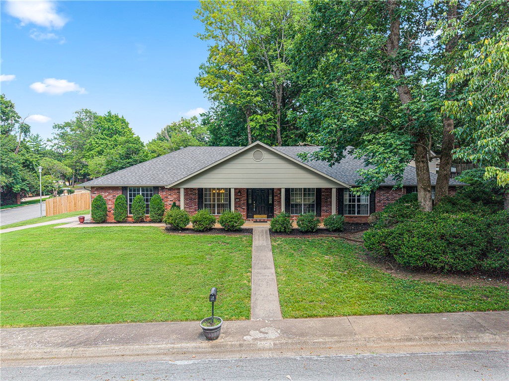 This one's a gem — a brick 4-bedroom, 3-bath home sitting on almost half an acre corner lot in Royal Oaks Estates. One level, 2,467 square feet, with brand new carpet just put in this year and a new roof in 2024. There's an eat-in kitchen, walk-in closets, even a second primary suite, plus a gas fireplace for chilly nights and a patio and porch for the good weather. The real showstopper out back is a two-story detached workshop — so much room for projects and storing your tools and toys. You've also got a community pool and tennis courts right there. And the location is unbeatable — super close to Gulley Park, right by the Walmart Neighborhood Market, and just minutes from everything that makes Fayetteville such a great place to live. Corner lots this size don't come up often — so worth a look.