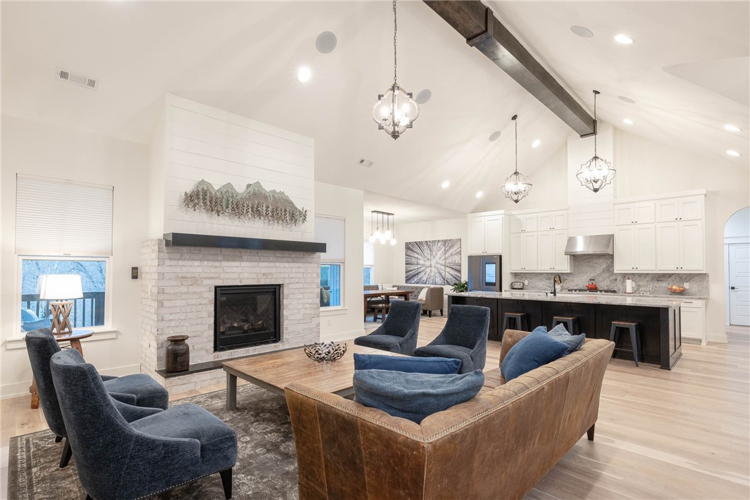 This new home is a dream! 5 bedrooms, an office, a bonus room, 2 living rooms, 4.5 bathrooms, 2 large decks w/ breathtaking views, and a massive 6-car garage, nestled on a wooded 3.66-acre lot. You'll be captivated by the home's stunning interior. The centerpiece is a large living room w/ a beautiful brick fireplace that adds warmth and charm. The expansive kitchen has double ovens and a large island. The luxury primary ensuite has a deluxe bathroom with a large walk-in closet and shower with two shower-heads, and a soak-in tub. There are 2 additional bedrooms on the other side of the main level, ensuring everyone has their own space, and for your guests, an ensuite. The downstairs level has more space to enjoy w/ a bonus room, a 2nd living space, a full bathroom, 5th bedroom, and also an office. The 4 car garage is climate controlled and has a climbing wall, and a workshop. This home is less than 3 miles to the future Bentonville Cycling Center, 5 min to Back 40 and other trails, and 15 min to Bentonville square