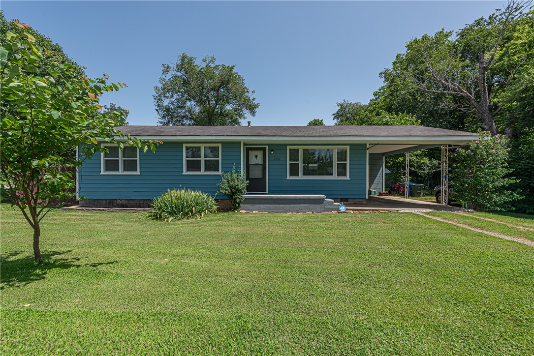 HOME SWEET HOME! Situated on a corner lot in West Fayetteville, this 3-bedroom home is conveniently located near dining, parks, trails, I-49, & University of Arkansas. Head inside to a spacious living room with beautiful hardwood floors & large picture window that fills the space with natural light. Eat-in kitchen offers ample cabinet storage, tiled backsplash, & stainless steel appliances, creating a functional space for everyday living. Relax in the primary bedroom, while two additional bedrooms provide flexible space for guests, home office, hobbies, or other needs. All three bedrooms feature hardwood flooring for timeless appeal. Outside, enjoy a large backyard with plenty of room for outdoor activities, gardening, or entertaining. Home also incl a covered carport with attached storage room for added convenience. Notable updates: New roof (2020) and new windows, tub, and hardwood flooring (2013). Don’t miss your opportunity to make this home your own!