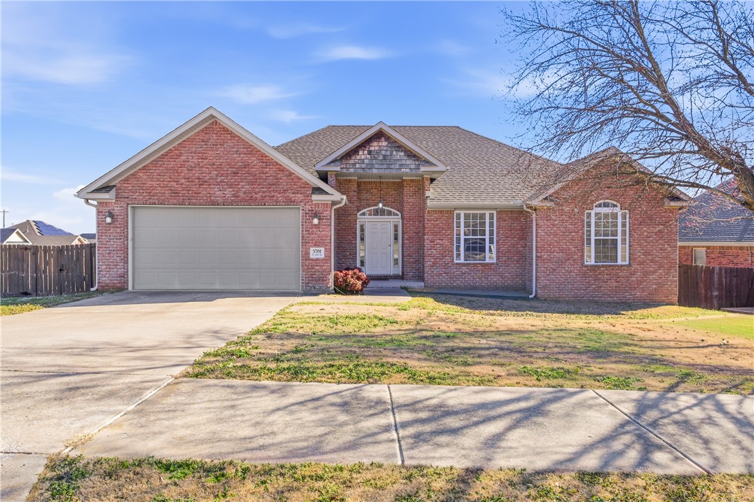 $5K BUYER CREDIT + NEW roof, NEW 6-ft privacy fence & NEW AC unit. Come home to Eagle Creek, a tucked-away subdivision in Bentonville – convenient to XNA, Walmart Distribution Center, schools, restaurants and shopping. This spacious, 2130 sq. ft., all brick home features a large living room bathed in natural light with wood mantle, gas-log fireplace and access to the deck. A movable granite-covered island offers flexibility in the kitchen with extra cabinets, pantry and breakfast area. Wood floors and tray ceiling anchor the dining room. The primary suite has a 2022 Safe Step, walk-in bathtub + large walk-in closet, private access to the deck, separate shower and dual vanities. French doors open to an office or playroom with wood floors, built-in desk and bookshelves. There are 2 additional bedrooms and guest bath. Dedicated laundry room has added storage and utility sink. Relax on the extended-covered porch – perfect for entertaining. Large backyard on a corner lot.