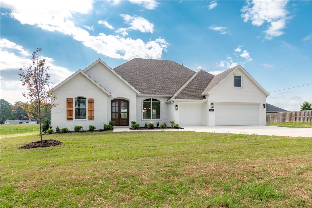 Beautiful brand new home currently being built on a spacious 1.04-acre lot! Estimated completion of Mid January 2027. Pictures are of the same floor plan built in different location.  Actual finishes and features may vary. This home offers a functional layout with everything but one room on the main level, plus a 3-car garage and spacious covered back porch. Inside, you’ll find hardwood floors, a gas fireplace, large picture windows overlooking the backyard, and an open living area centered around a beautiful kitchen with a large island, gas range, premium quartz countertops, and custom cabinets extended to the ceiling. The primary suite features a tiled walk-in shower and jetted tub. Located just minutes from shopping, dining, parks, trails, schools, I-49, Fayetteville, and all the great amenities Northwest Arkansas has to offer. 1-year builder’s warranty, gutters, and blinds included!