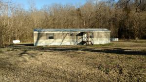Move-in ready mobile home located on 2 acres +/- on Highway 412, 9.4 miles west of Alpena (1.67 miles east of Osage) in Alpena School District. This would make a great starter home or a nice rental. This 16  64 mobile home offers 2 bdrms/2baths and the property offers a 25.5 x 71 x 10 shop building, chicken coup, rabbit hutch, fire pit, storm shelter, above ground pool, trampoline and has Dog Branch Creek running through the south side of the property. There are fruit trees (two pear trees and a peach tree) and a nice garden spot. Several updates include: Dec. 2015: 1000 gal septic tank, 200 amp meter loop, well pump with new P.E. pipping, grey water drain tank, HVAC system; 2016: front porch and rear deck and fence for small dog; 2017: breaker box and power supply to shop.