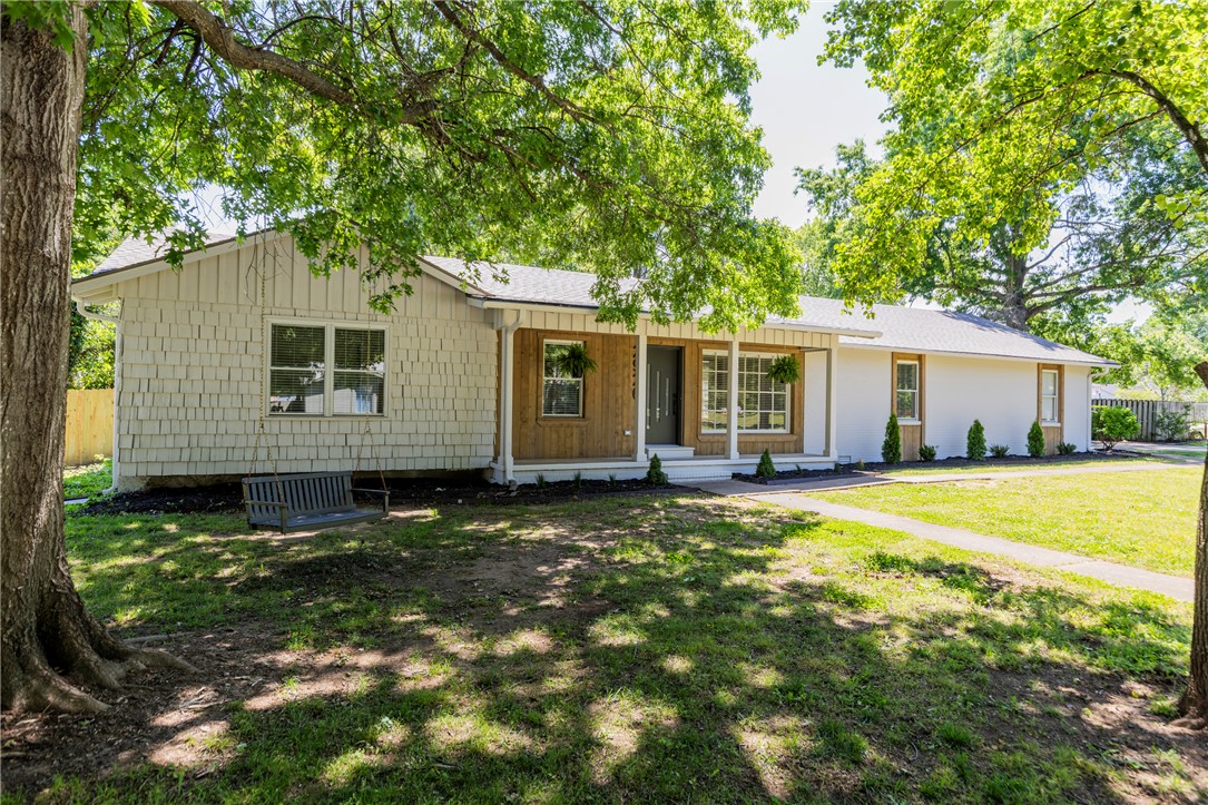 Welcome to this fully remodeled ranch, perfectly situated on an oversized corner lot in the center of Fayetteville. The home has unbeatable walkability, just steps from Confident Coffee, restaurants, schools, and the beloved greenway trail. Inside, every detail has been thoughtfully updated with sleek, designer finishes and a clean, modern aesthetic. The completely renovated interior includes high-quality LVP, new cabinetry, gas range and dishwasher, plumbing fixtures, lighting, hardware, tiled showers and white oak accents. A versatile bonus space offers the ideal setup for a home office, creative space, or additional storage. The roof is also brand new. Step outside to enjoy a spacious new deck—perfect for relaxing or hosting—overlooking the expansive lot with mature trees and a large storage shed that conveys. With ample parking and a prime central location, convenience is at your doorstep. This is a rare opportunity to own a turnkey, designer-updated home in one of the most desirable and walkable areas in town.