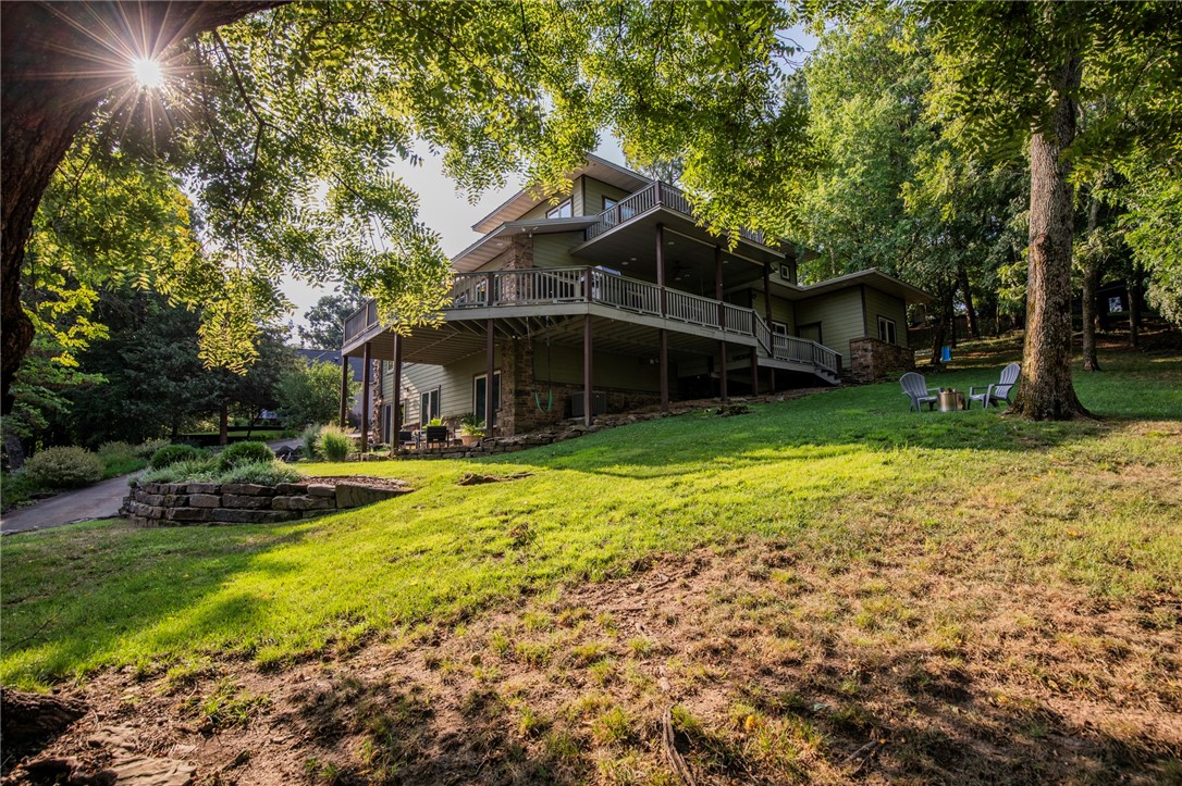 Tucked away on Fayetteville's desired Mt. Sequoyah, this beautiful "house in the trees" offers exceptional views of all of NWA! Featured in At Home Arkansas for its eco-friendly design, this stunning 3 level home is a reflection of its natural surroundings. Natural elements were used in every detail: walnut posts sourced from the property on display in the living room, locally-milled cherry cabinets, & hickory & natural stone floors. The triple-pane, vinyl clad windows offer breathtaking sunset views. In addition to the 3 bedrooms, there is a built-in office space, basement flex space with wet bar area, and multi-use room adjacent to the primary bedroom. The primary suite boasts a clawfoot tub, walk-in shower, and multiple skylights. Maximizing space, one of the downstairs bedrooms has a built-in Murphy bed and sliding barn doors. You'll appreciate the natural elements of the professional landscaping with accent boulders, stone steps & mature, native plants. Located just 1.5 miles to Dickson St & U of A. HVAC 2019.