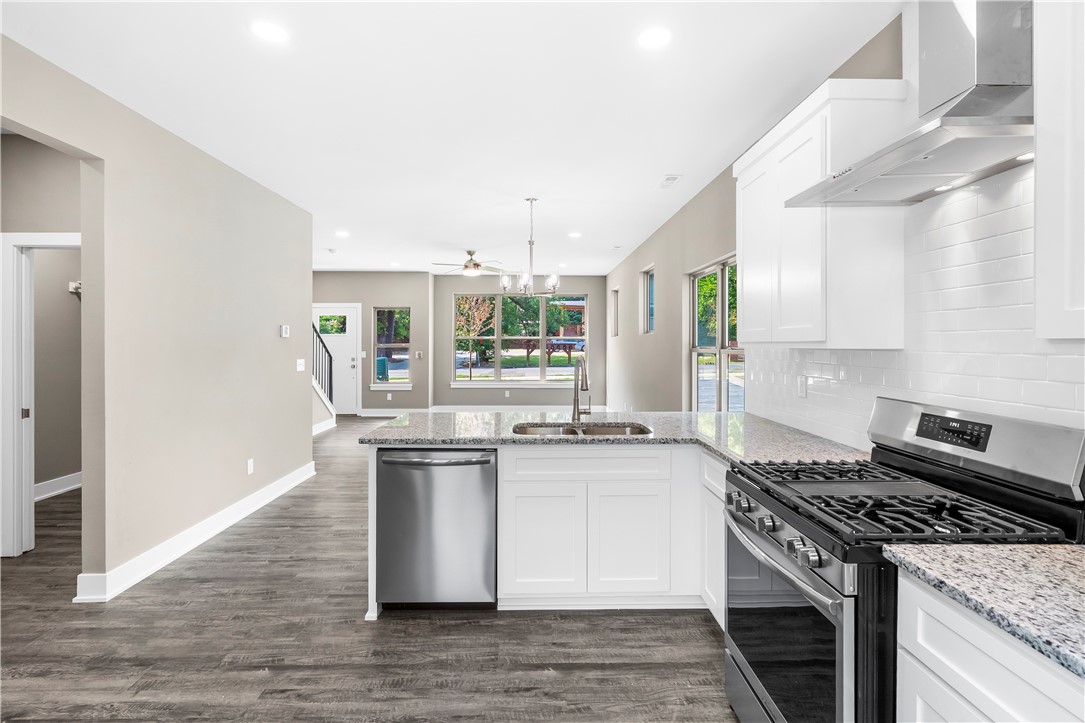 Discover turnkey luxury in this newly built Fayetteville home, perfectly positioned for the ultimate walkable/bikeable lifestyle. Just moments from the U of A campus, the Razorback Greenway trail, dining, and shopping. This sophisticated 3-bed, 2.5-bath residence features premium upgrades including extra-thick granite counters, a full suite of Frigidaire Gallery appliances with a gas range with a convection/air fry oven, and a central tech hub with high-speed ethernet. Enjoy a private, low-maintenance yard and coveted off-street parking for 3 cars. With I-49 less than 5 minutes away, all of Northwest Arkansas is at your doorstep. This is effortless, elevated living.
