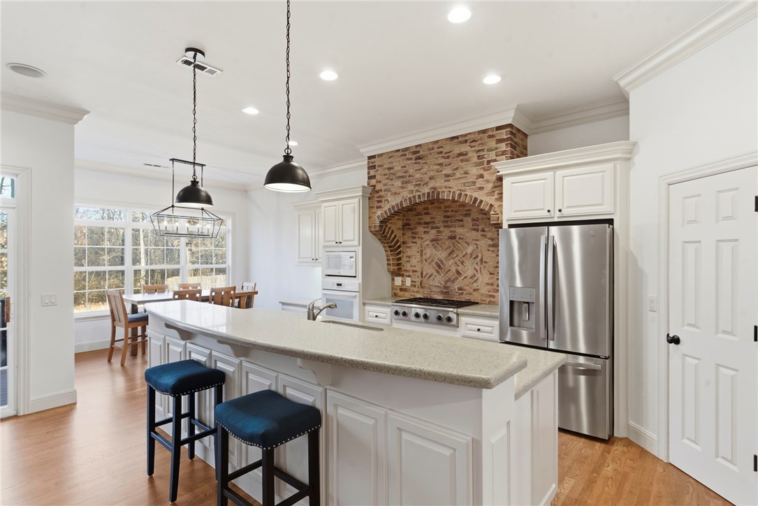 Welcome to this stunning home in the gated golf community of Shadow Valley Country Club, offering luxury living in the heart of Northwest Arkansas just minutes from Pinnacle Hills Promenade, Walmart Home Office, Sam's Club HQ, Mercy Hospital, top dining, shopping, entertainment, and I-49 access. Enjoy resort-style amenities including a championship golf course, clubhouse, pool, fitness center, restaurant, pickleball and tennis courts, pro shop, and 24/7 gated security. This spacious home features 2 bedrooms and 1.5 baths on the main level, plus 3 bedrooms, 2 full baths, and a bonus room upstairs. Filled with natural light, the open layout offers a private backyard, 3-car garage, extended driveway, recent flooring and paint updates, plus a storm shelter for peace of mind. Golf membership conveys with the home.