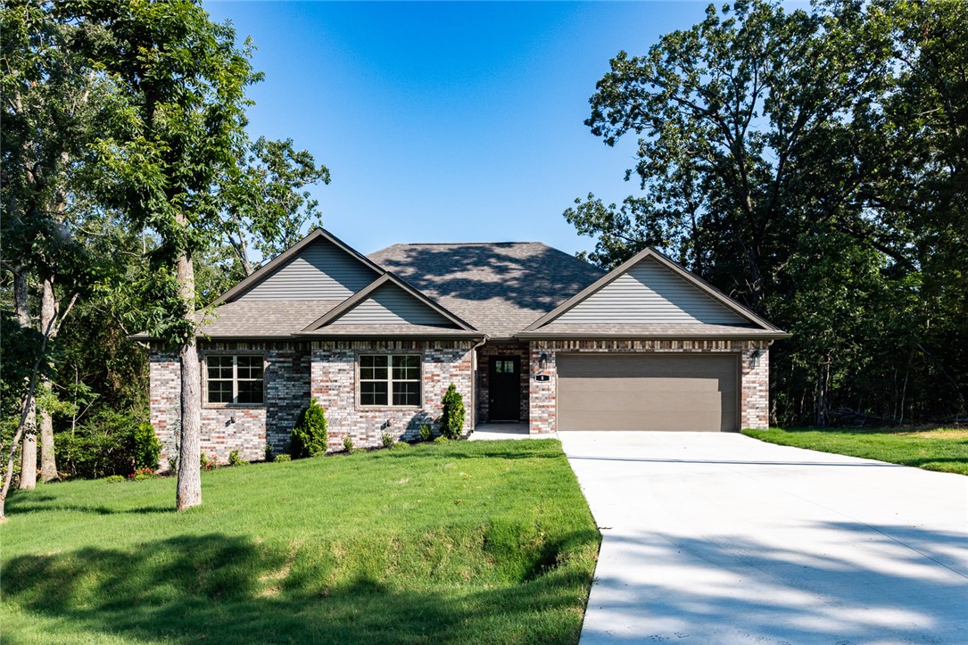 Experience the best of Bella Vista in this beautiful new construction home offering 1,950 sq. ft., 3 bedrooms, and thoughtfully designed living spaces. The open floor plan is perfect for everyday living and entertaining, while the spacious primary suite features a spa-like bathroom with an oversized walk-in shower and dual shower heads for a luxurious retreat. Enjoy peaceful views from the backyard, creating the perfect place to relax after a day outdoors. Ideally located just minutes from Bella Vista's renowned golf courses and only 13 minutes from the new OZ Trails Bike Park, this home offers easy access to world-class mountain biking, hiking, and recreation. Whether you're looking for an active lifestyle or a quiet place to unwind, this home combines modern comfort with everything Northwest Arkansas has to offer.