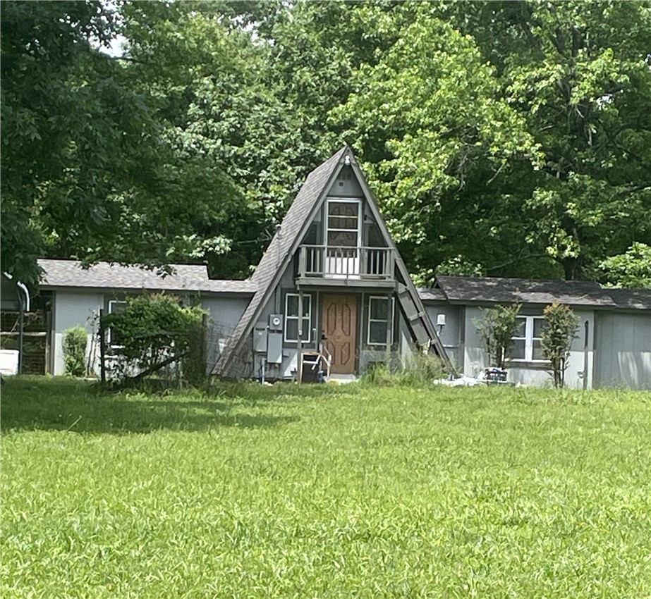 Get-away retreat? Hunting cabin? Downsized home? Investment for a VRBO? This unique property sits on 7+ acres! Lots of wildlife, and there's a pond! Just a short distance away from the National Forest! Well insulated 984 sf main house. Downstairs, find 1 bedroom (HUGE walk-in closet), 1 bathroom; living room, laundry area, kitchen/dining; a split loft upstairs. Interior has been freshened with new paint; living room floor refinished; new LED lighting. H/A provided by 4 mini-splits. 7-year old shingled roof; 3-year old water heater; handicap accessible. Property is fenced. Backyard is double-fenced. There's also a handicap-accessible TINY HOUSE with water, electric, on-demand water heater, AC with its own circuit~just needs a bathroom added;. Multiple outbuildings for tons of storage. 4 carports! One is tall, with RV hookup and water faucet, but no septic. Space to add multiple cabins if you want to have a village! Propane generator conveys-provides power for both houses. Two outdoor faucets.