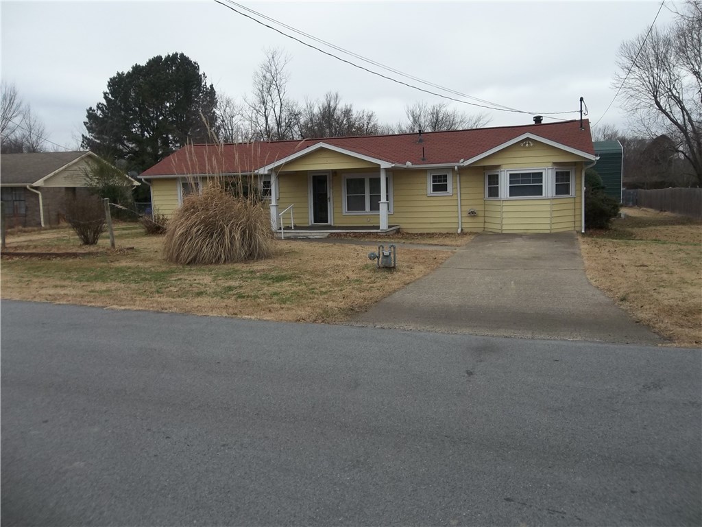 Well kept home that is move in ready.  Garage has been converted into a very nice den with wood burning stove.  Gravel drive south of the house leads to spacious backyard with carport and garage/workshop.  Has walk-in shower and closet and beautiful wood floor.