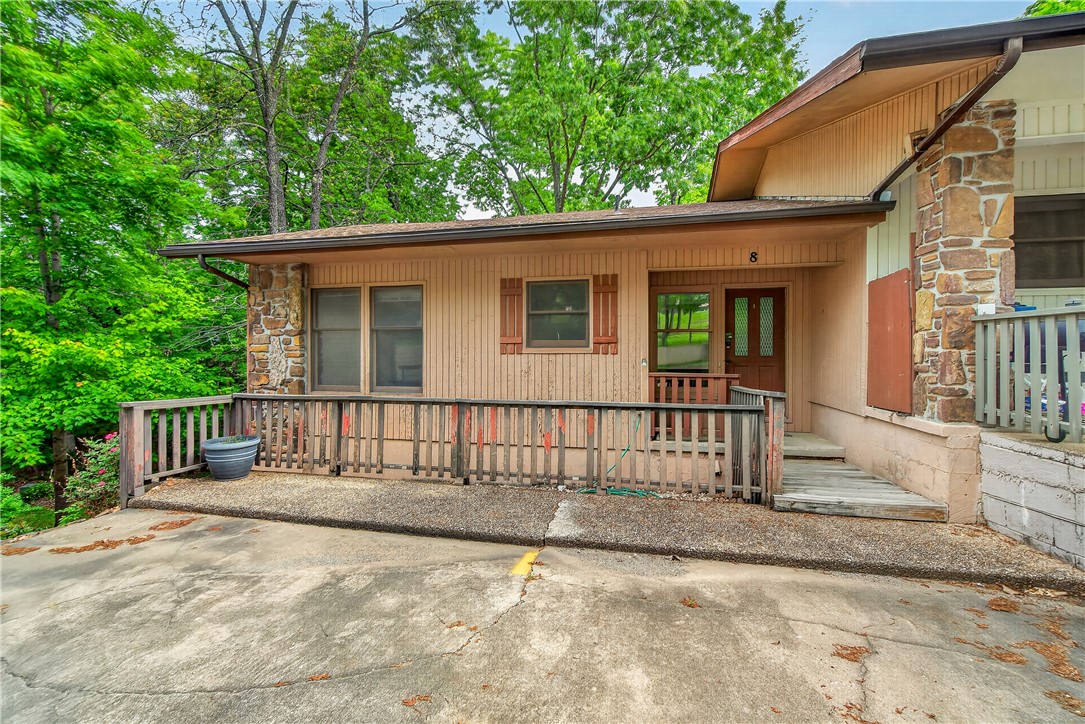 Unbeatable Location and Price!!! This spacious end-unit townhome is located next to the Bella Vista Recreation Center, just one mile from the top of the OZ Trails bike lift and minutes from Downtown Bentonville. Offering 3 bedrooms (also one extra large room without a closet), this townhome is ideal for a primary residence, vacation home, or income-producing property. The main level features a welcoming living area with a beautiful stone fireplace and a primary bedroom with a full bath on the first floor. The lower level includes additional bedrooms and a large bonus room perfect for guests, office, or flex space. All bedrooms feature sliding glass doors with direct access to a deck, creating a great indoor-outdoor connection. Located near golf courses, trails, parks, pools, tennis courts, and more - perfect for enjoying the outdoor lifestyle. All appliances convey, including washer and dryer. Priced to allow for updates and personal touches. Great opportunity for investors or buyers looking to add value.