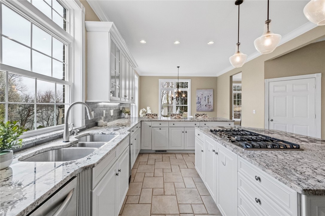 Welcome to this stunning lake home with beautiful Beaver Lake views and a coveted boat slip in the community dock right across the street! As you enter the home you are greeted with a grand foyer with large 2 story windows that let in incredible natural light. The kitchen is large and updated with granite countertops and appliances. The main floor features the primary bedroom, office, formal dining, formal living, kitchen, eat-in kitchen, and informal living room. Upstairs features 2 large bedrooms with en-suites, a large media room, a large bonus room/bedroom, and an additional full bathroom. The walk-out basement features 2 more large bedrooms with en-suites, a laundry room, and a game room. Sip your cup of coffee and enjoy the view on the large back deck. Only minutes from Prairie Creek Marina and downtown Rogers. Come and see why "Life Is Better at the Lake." Boat slip for serenity: 10'x30' bay 3 of a 6 slip community dock.