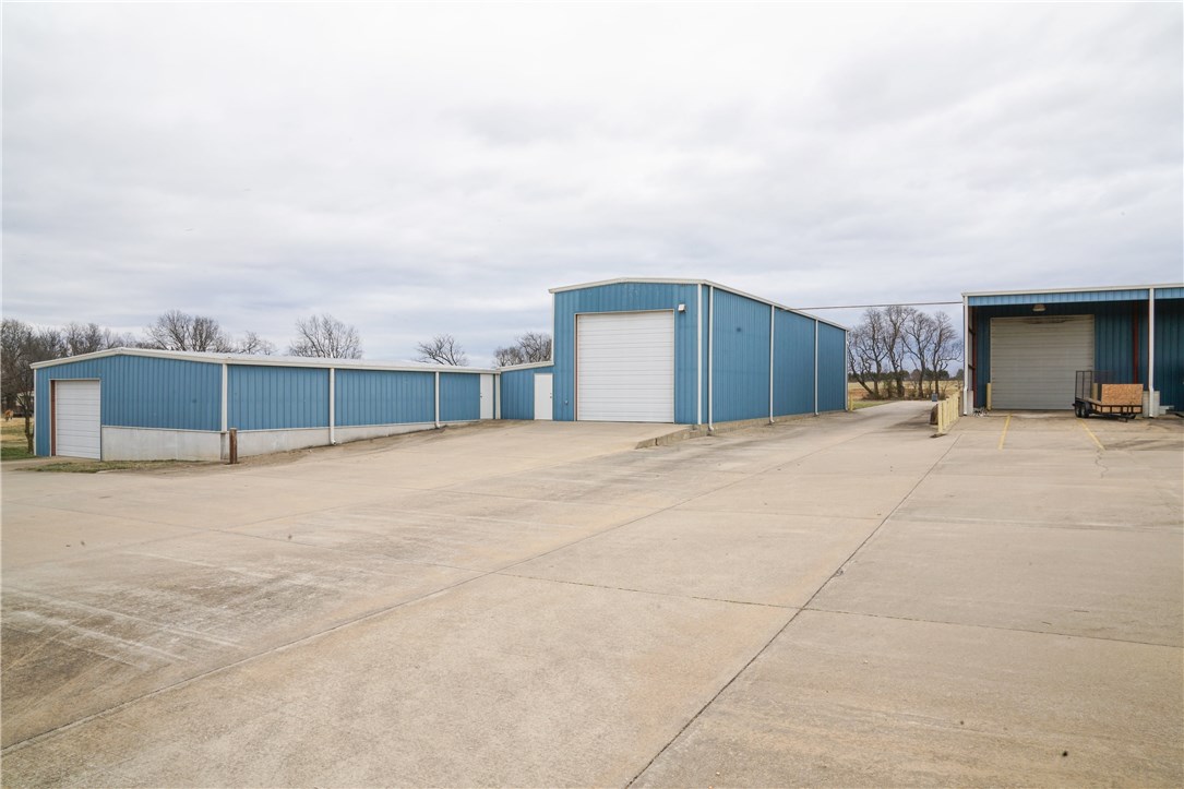 Best buy just outside the Lowell city limits.  Manufacturing or warehouse facility that has it all; 5000sf office, 15000sf manufacturing floor or maintenance/warehouse space, 2000sf service/wash bay, 1500sf shop, and 2000sf brick home (as is).  Perfect setup & location for a trucking business. Incredible amount of concrete parking & room to expand. It is situated just a mile from the Highway 265 expansion.  This property has an incredible amount of features for the price.  Use part & lease out the rest.