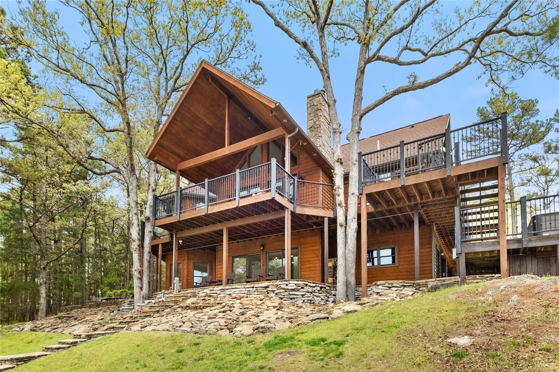Luxury lake front living with year round views of Beaver Lake on 7.15 acres. This custom designed 5 bed/3.5 bath home was built for hosting with multiple living spaces, eating areas, game room, ample parking and multi-level deck with built-in hot tub. Access your private two-slip dock via a flagstone stairway or ATV path. Don't forget the oversized detached garage with workshop area for additional parking and all of your hobby/storage needs. This is more than just a home; it's a rare opportunity to own a piece of paradise where every day feels like a vacation! 

Boat dock w/ lifts measures 31ft x 40ft. Extensive interior update - oak hardwood floors, trim, and paint - 2020. Cedar siding/deck staining, driveway resealed - 2022. Leaf Filter guards added - 2022. Home generator and Ozone water treatment system. New Culligan water softener and RO water filter - 2022. Fully owned solar system - 2022. Air Scrubber - 2023. New exterior doors and south-facing windows - 2023. Septic pumped and extended - 2023. Agent Owned.