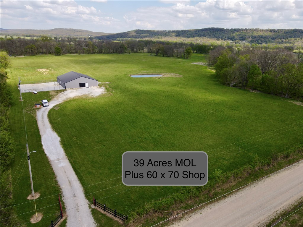 Discover the perfect mix of productivity, recreation, and opportunity with this 39± acre property just 3 minutes east of the growing town of Elkins, Arkansas.

This versatile tract features gently rolling, well-maintained pasture ideal for livestock, hay, or building your dream home with scenic views and a peaceful setting.

Water features include two ponds and a live creek, providing excellent water sources for livestock and attracting abundant wildlife.

The property also includes a 60x70 shop currently set up as a turnkey dog kennel with removable kennels, offering flexibility for business use, storage, or livestock.

With easy access and close proximity to Fayetteville and Northwest Arkansas amenities, this property is perfect for farming, recreation, investment, or a ready-to-go business opportunity.

Shop is heated / cooled and has water and plumbing.  Kennels are modular and easily removable if the buyer does not need them.