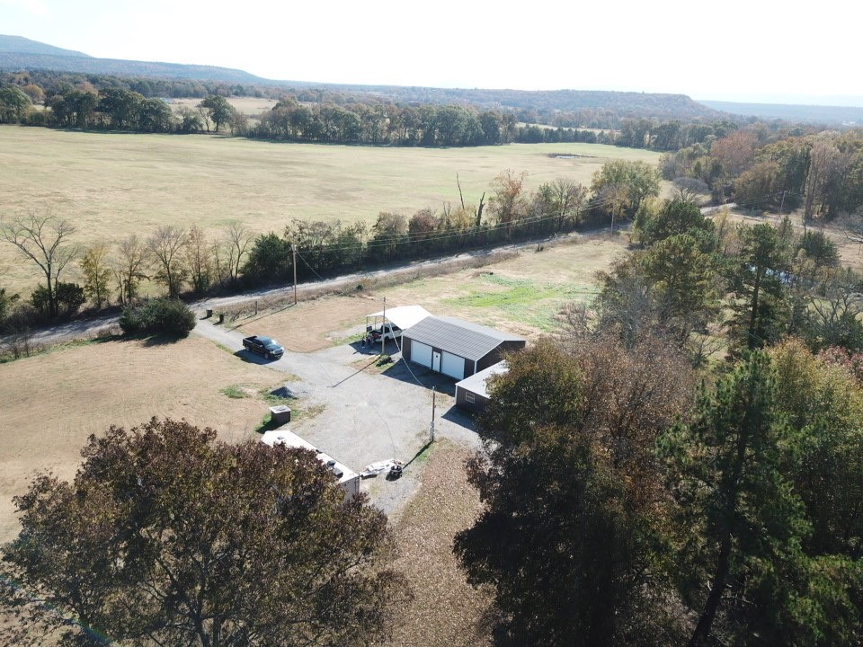 Nestled on 2.48 gorgeous acres with an exceptional view of Mount Magazine, this property comes fully equipped with all the essential utilities and an installed septic system.
This property is perfect for those envisioning a custom dream home or seeking a peaceful retreat, this location offers unmatched proximity to the National Forest, scenic ATV trails and thriving wildlife. The property's natural setting provides the ideal escape while remaining minutes away from outdoor adventure. Existing structures enhance the property's functionality and value, including a 30x35 shop with electric in place, pole shed, barn/shed, 2 car carport and RV hookup- offering versality for work, storage or recreation.to experience the serenity, natural splendor and full potential this remarkable property offers, a site visit is essential! Schedule your private tour today!