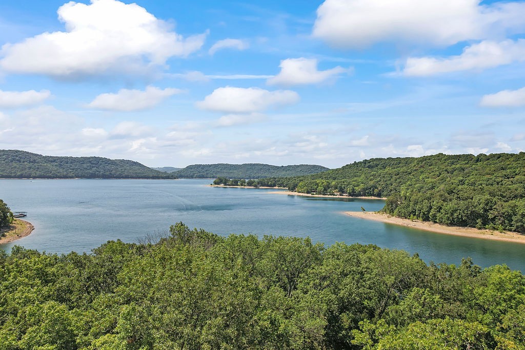 Heavenly lakefront lot in the Indian Point Subdivision! Nestled on over half an acre with impressive views of Beaver Lake. Gradual slope to the water with 155 feet of shoreline. The Indian Creek Trails and Park are just moments away providing the family a place to have fun together. Several public boat launches nearby giving you the chance to live the lake life. Do not miss this opportunity to own this stunning property!