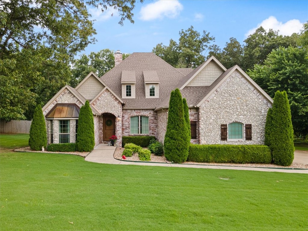 Stunning home in West Haven on a level 1.13 acre wooded lot! Convenient access to I-49! Features include 4BD's (3 on main level) / 4BA's, office, formal dining, game room, and media room! You will be greeted by a large entry leading to a living room adorned with exposed brick, stone fireplace, and elegant wood beams. The living area features the added comfort of heated floors, while the kitchen offers an abundance of cabinet space. The primary bedroom features a charming bay window with outdoor access. Additional highlights include a spacious laundry room with extra storage and a utility sink. Step outside to discover a heated saltwater pool with an automatic cover and an outdoor kitchen ideal for hosting gatherings. Roof was replaced in 2018.