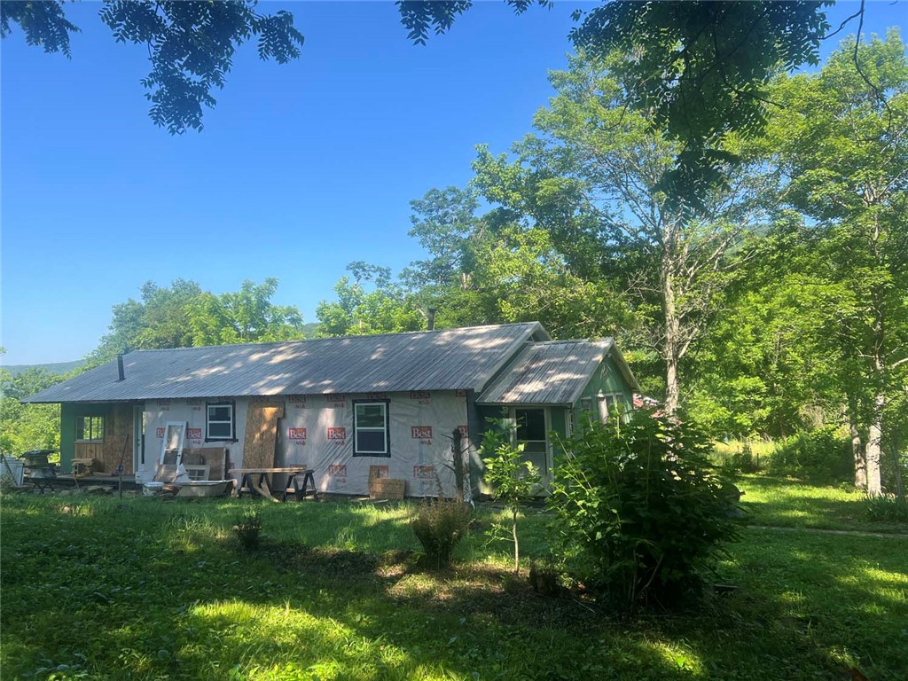 Step back in time to a rare piece of Ozark history on this remarkable 67-acre farm, with roots dating back to the late 1800s. There is a farmhouse that is currently undergoing renovations, along with several historic barns, outbuildings, storage structures, and a root cellar. Some of the buildings still showcase original cedar support beams from the late 1800's.

The land is well-equipped for livestock or farming operations with fencing and cross-fencing throughout, multiple pastures, a working well, natural springs, and rural water available at the road. The eastern boundary adjoins National Forest land, providing direct access to thousands of acres for hunting, hiking, and exploring.

Wildlife is abundant, making this an excellent property for hunters, outdoor enthusiasts, or anyone seeking a peaceful rural retreat. Conveniently located with access to Deer, Jasper, and Clarksville, the property is also near popular Jeep and off-road trails, adding even more recreational opportunities.