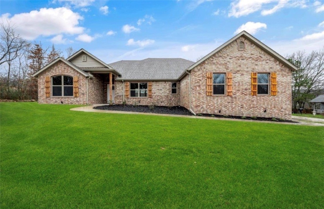 Stunning 2024-built home on a corner lot in Bentonville School District. 3 bedrooms, 2 baths, and 2,032 square feet. This split-bedroom floor plan blends modern comfort with everyday functionality.

Open-concept living, dining, and kitchen area filled with natural light and elevated finishes throughout. Hardwood floors and gas log fireplace create a warm focal point. Kitchen boasts granite countertops, custom cabinetry, a spacious pantry, and a large island.

Primary suite features a spa-inspired bath with dual vanities, custom tile shower, soaking tub, and a walk-in closet that connects to Laundry Room. 

Covered Deck, flat, and fully fenced yard — perfect for relaxing after a ride or hosting friends. Garage features tall ceilings and space for bikes, tools, and all your outdoor gear.

Located mins from Bella Vista’s Mountain Biking Trail Systems and NEW Bike Lift access, this home is a dream basecamp for outdoor enthusiasts. Quick access to trails, lakes, golf, and everything that makes NWA so special!