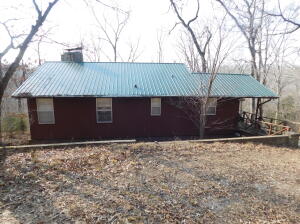 This 2217 sq ft, 3 bedroom, 2 bath home on 3.6 wooded acres with good views is located in the heart of the Ozarks. Close to Dogpatch and Johnny Morris' planned Marble Falls Nature Park development in Newton County. Features of this home include vaulted living room ceiling, finished basement with large game room, 3 fireplaces (living room, game room, bedroom) with native stone rock work, and concrete topped safe room in the basement. Rural water and well.In addition to it being a great primary home, it would be perfect for your vacation home or it could be used as a nightly rental. It is just 2 miles off of Hwy 7 and only 3 miles from Dogpatch.