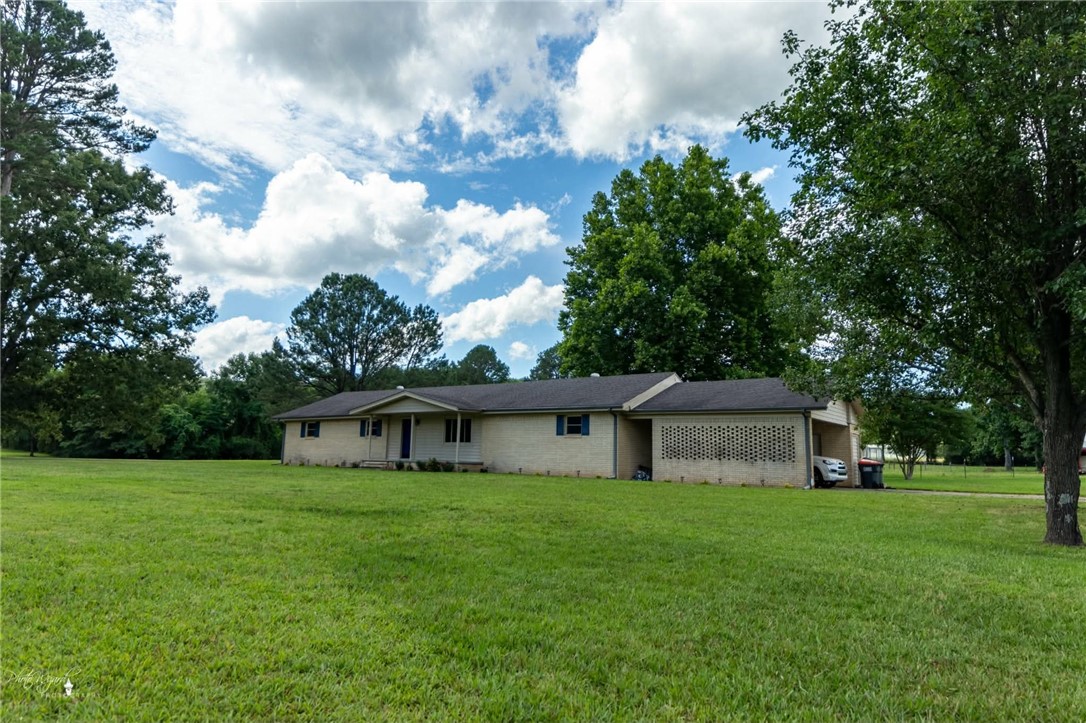 Discover the inviting single-family residence at 232 CENTER VALLEY RD in Russellville, Arkansas. Built in 1968, this move-in-ready home offers a comfortable 2536 square feet of living space, designed for effortless living and entertaining. The heart of the home, the living room, provides a welcoming atmosphere, centered around a cozy fireplace – perfect for intimate gatherings or quiet evenings. Indulge in the thoughtfully appointed bathroom, featuring a luxurious jetted bathtub for ultimate relaxation, a convenient double vanity for shared routines, and a spacious walk-in shower for a refreshing start to your day. Beyond the interior, an attached carport offers practical shelter, while the charming porch invites leisurely moments. An outdoor dining area extends your living space, ideal for al fresco meals and enjoying the Arkansas air. For added convenience, a dedicated laundry room simplifies daily chores. This ranch-style home, with its three comfortable bedrooms, is ready to embrace its next chapter.