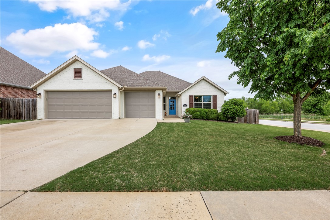 Fresh white curb appeal meets a smart, functional layout in this beautifully maintained 4 bed, 3 bath home on a spacious corner lot. Inside, you’ll find a desirable split floorplan with two bedrooms on each side—ideal for privacy and flexibility. A formal dining room sits at the front of the home, while the large living area opens seamlessly to the kitchen, creating an inviting space for everyday living and entertaining. The kitchen features granite countertops, ample cabinet storage, pantry, refrigerator, and an island with bar seating. Cozy up by the gas fireplace or step outside to the oversized covered back deck—perfect for relaxing or hosting. All just minutes from I-49 for easy access to everything Northwest Arkansas has to offer.